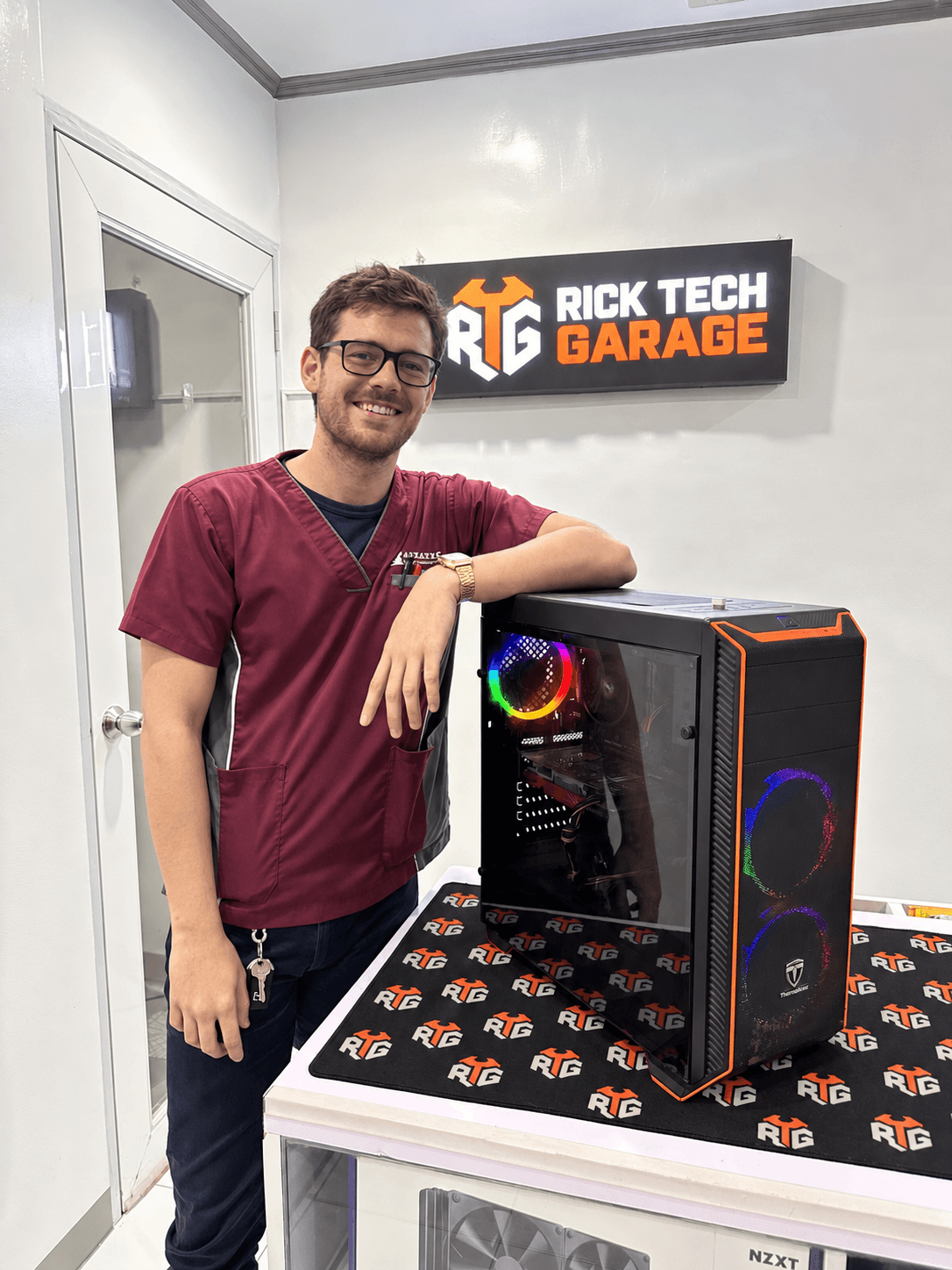 Person beside a gaming PC in the RTG-branded workshop